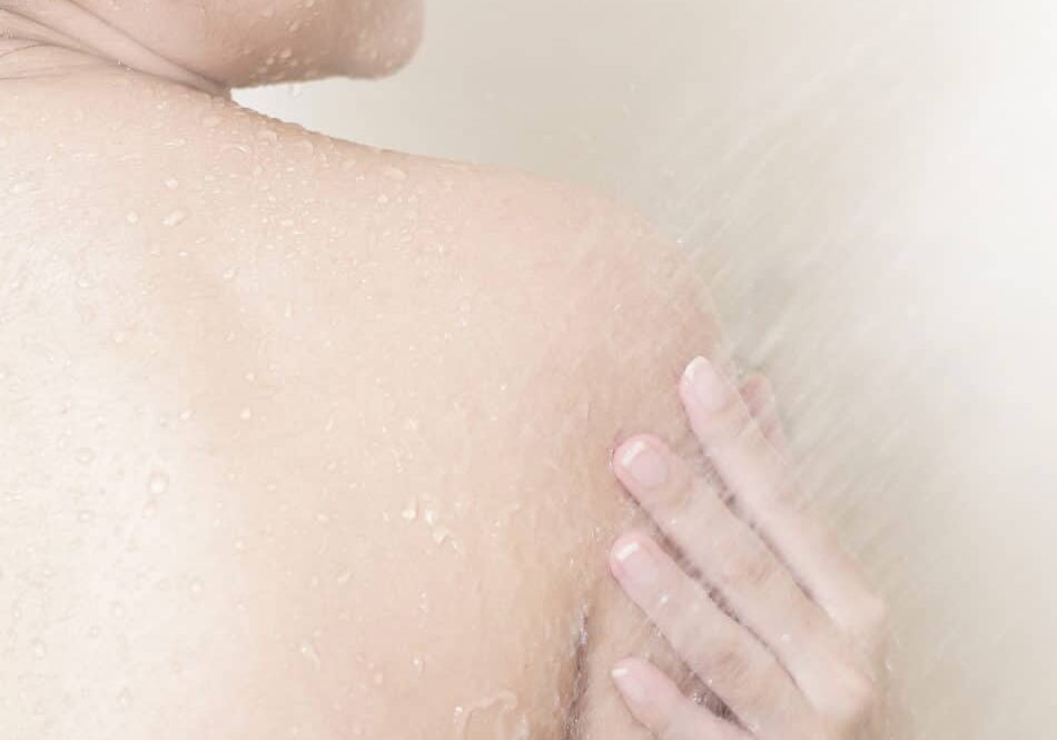 Happy  beautiful woman is taking a shower